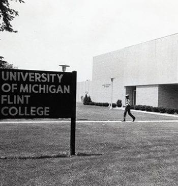 Young man walking outside UM Flint College